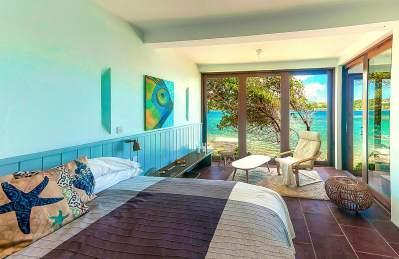 Vibrant beachfront bedroom with ocean view and themed decor