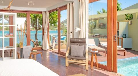Luxurious room with pool and scenic view in high-end resort.