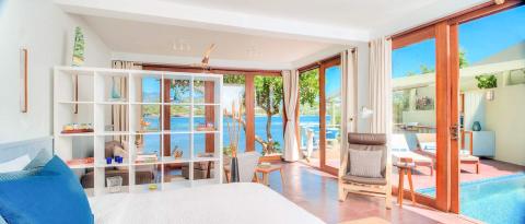 Resort room with sea view, pool, and stylish decor perfect for a relaxing getaway.