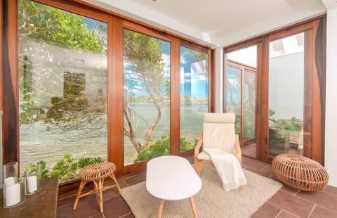 Cozy room with panoramic view through large windows, comfy chair and decor.
