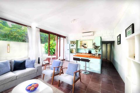 Modern open-plan living room and kitchen with stylish decor and ample natural light.