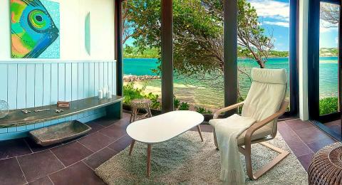 Serene indoor lounge overlooking scenic waterfront with stylish decor.