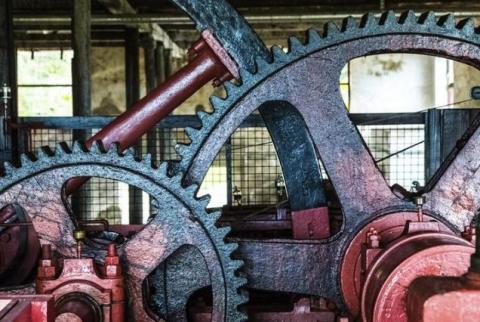 Close-Up of Interlocking Industrial Gears Showcasing Rugged Engineering Precision Close-up of large interlocking metal gears with rust in an industrial machine, showcasing detail.
