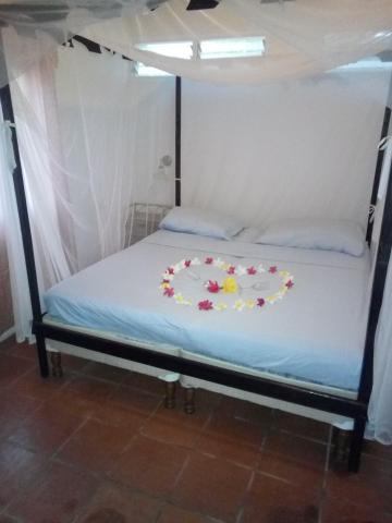 Romantic bedroom with four-poster bed and heart-shaped petal design
