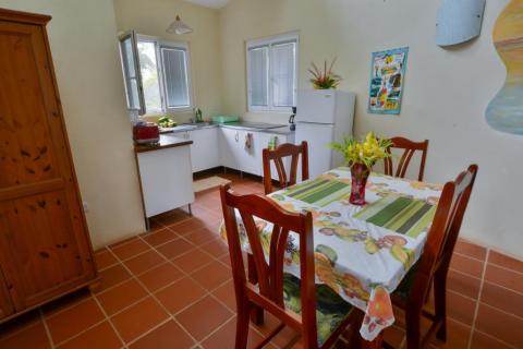 Cozy kitchen with dining area, wooden furniture, and colorful decor