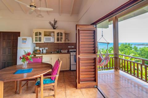 Cozy vacation home interior with modern kitchen and sea view balcony