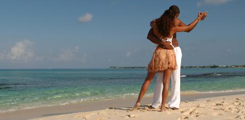 Cayman Tourism Board Dance of Serenity by the Sea This image captures a moment between two people on a beautiful beach