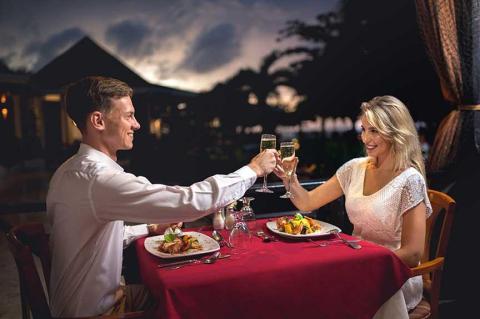 Romantic dinner for two outdoors with champagne toast at twilight.