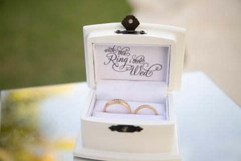 Gold wedding rings in white box with 