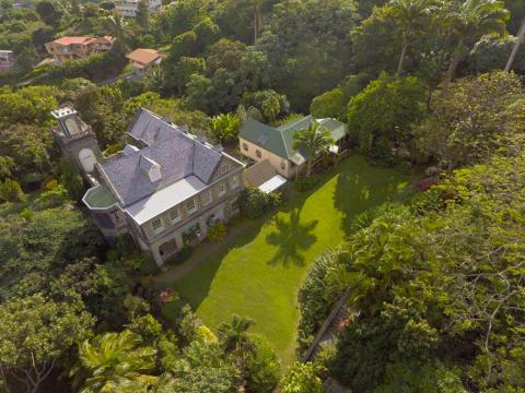 Stately Stone Residence Aerial View With Greenery Stately stone residence with bell tower and lush greenery from above.