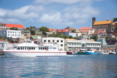 Admiral Bay Ii Ferry At Tropical Harbor Town Admiral Bay II ferry docked in a vibrant harbor with hillside town background