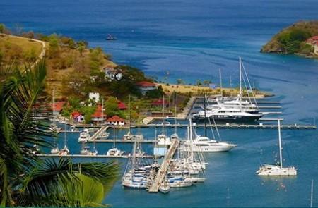 Scenic Marina View With Yachts And Tropical Hills Scenic marina view with yachts, green hills, and red-roof buildings under a tropical ambiance