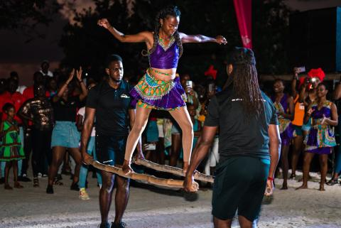Traditional Pole Dance At Cultural Night Festival Traditional pole dance at night festival with vibrant crowd watching.