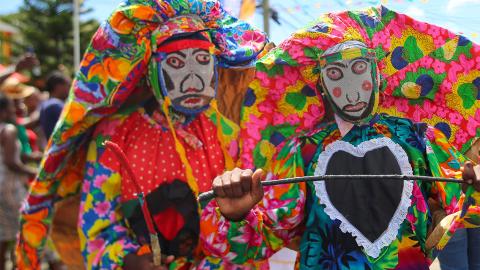 Traditional Masked Parade In Colorful Costumes Participants in vibrant costumes at a traditional cultural parade.