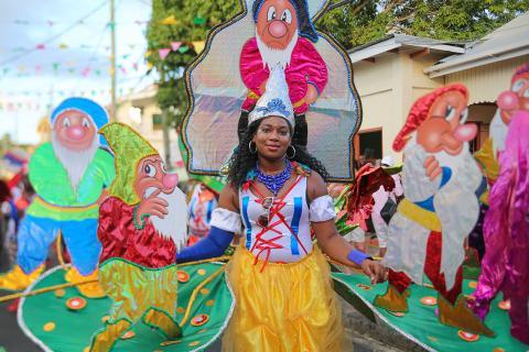 Snow White Themed Parade Float At Cultural Festival Snow White themed parade float with colorful dwarf figures and festive crowd
