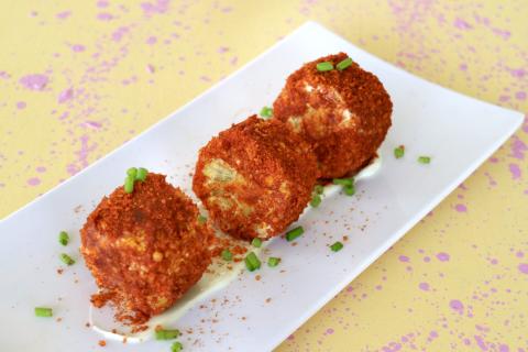 Crispy Cheese Balls With Sauce Appetizer Crispy cheese balls on creamy sauce with spring onions, appetizer