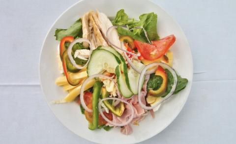 Healthy Fresh Salad With Chicken And Vegetables Colorful fresh salad with cucumber, peppers, onion, tomato, avocado, cheese, chicken on a plate