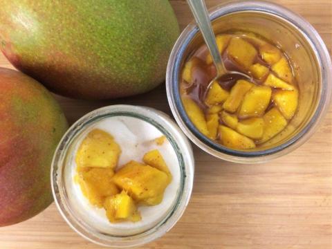 Fresh Mango Desserts-Snacks On Wooden Counter Fresh mango, mango cubes in syrup, and mango yogurt dessert on wooden counter