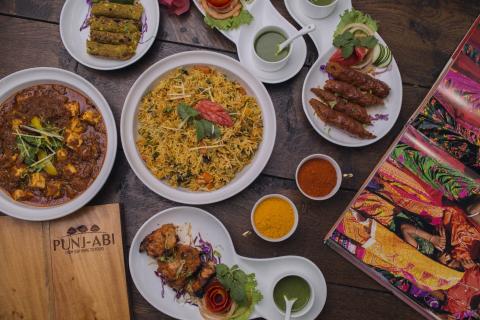 Authentic Punjabi Cuisine Feast - Indian Dishes Array of Indian dishes including chicken curry, biryani, seekh kebabs, and tandoori chicken