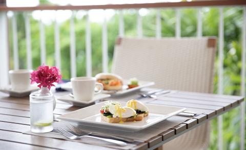 Garden Breakfast Setting With Eggs Benedict And Coffee Outdoor breakfast for two with eggs benedict and coffee in a garden setting