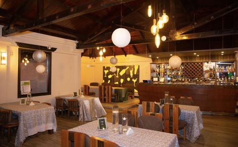 Cozy Restaurant Interior With Wooden Decor And Bar Cozy restaurant interior with wooden beams, bar, and modern art decor