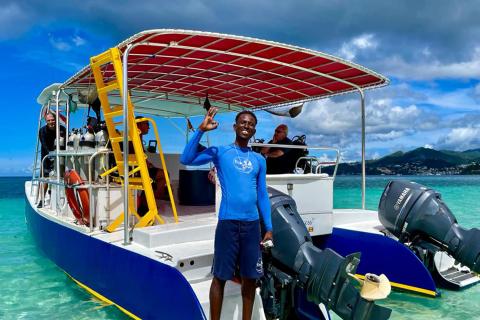 Scuba Diving Adventure In Turquoise Waters Diving boat with crew in turquoise waters, ready for scuba diving adventure