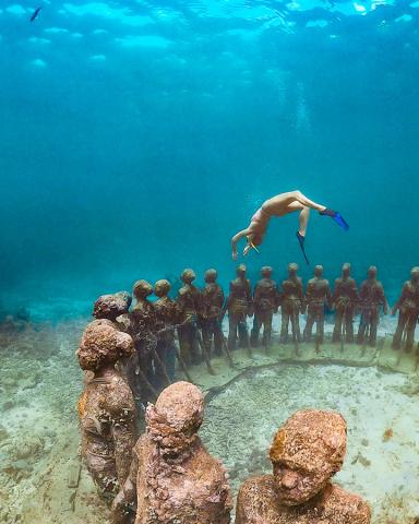 Diver Explores Underwater Statue Circle Reef Freediver explores underwater statue circle in a clear marine park