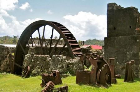 Antique Sugar Cane Mill Water Wheel Ruins Old metal water wheel and machinery in ruins of a sugar cane plantation
