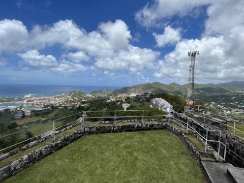 Scenic Coastal Town View From Historic Hilltop Coastal town view from hilltop with stone railing and communication tower