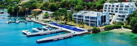 Luxury Waterfront Resort With Marina And Pool Luxurious waterfront resort with marina, pool, and beach in tropical setting.