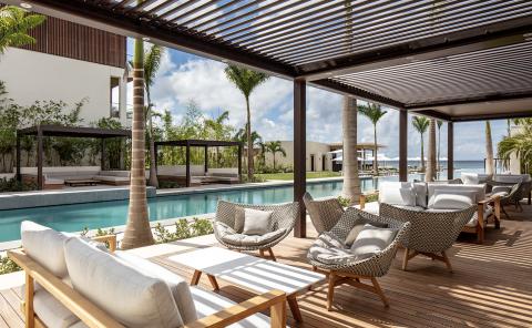 Luxury Resort Pool With Wooden Deck And Pergolas Luxury resort pool with wooden deck, pergolas, and lush landscaping