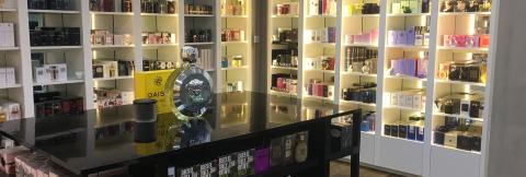 Versace Perfume Display In Modern Shop Interior Interior of a modern perfume shop with Versace on display.