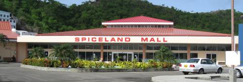 Spiceland Mall Exterior With Red Roof And Green Hills Exterior of Spiceland Mall with red roof and lush greenery in tropical setting