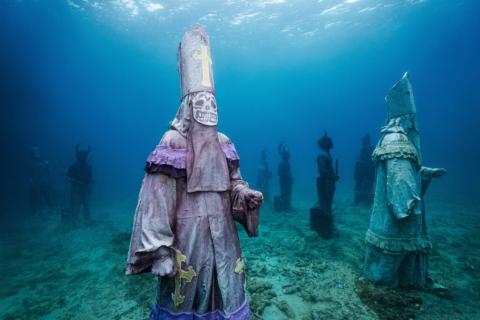 Underwater Statue Art Installation - Mystical Scene Underwater sculpture park with mystical statues in robes, eerie light.