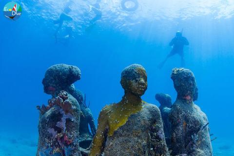 Underwater Sculpture Garden Explored By Divers Scuba divers explore an artificial reef made of sculptures underwater.