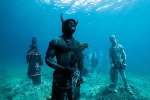 Underwater Sculpture Park With Diverse Cultural Statues Underwater sculpture park with statues representing diverse cultures in a mystical setting.