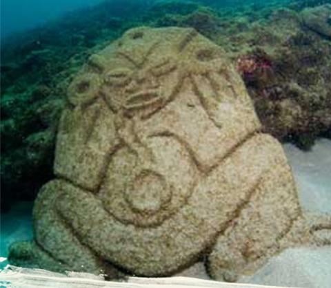 Underwater Sculpture Of Mythical Frog Figure Underwater sculpture resembling a mythological frog-like figure on seafloor.