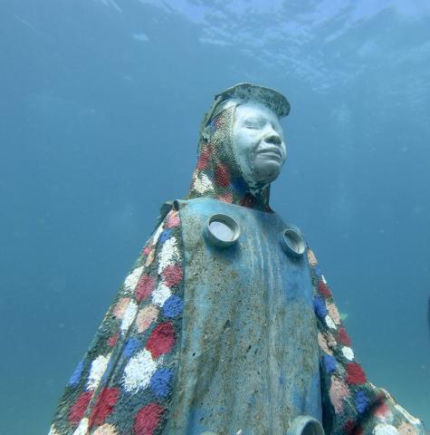 Underwater Sculpture Artistic Aquatic Headdress Figure Underwater sculpture park, human figure with patterned headdress, aquatic-themed body.