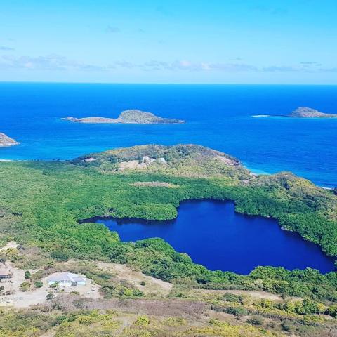 Aerial View Of Coastal Landscape With Blue Lake Aerial view of a coastal landscape with a blue lake, islands, and clear waters.