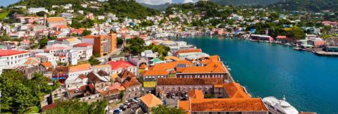Colorful Caribbean Coastal Town With Lush Landscape Colorful Caribbean coastal town with a busy harbor and lush hillsides