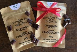 Two organic 75% cocoa chocolate bars from Grenada, one with a red ribbon.