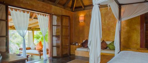 Warm, cozy room with daybed, sheer curtains, and soft lighting.