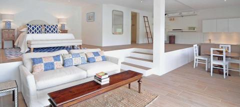 Modern multi-functional living space with bedroom, kitchen, and lounge areas.