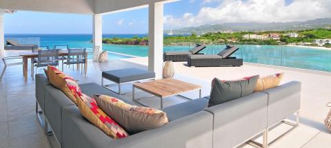 Stylish outdoor lounge with infinity pool overlooking a seaside