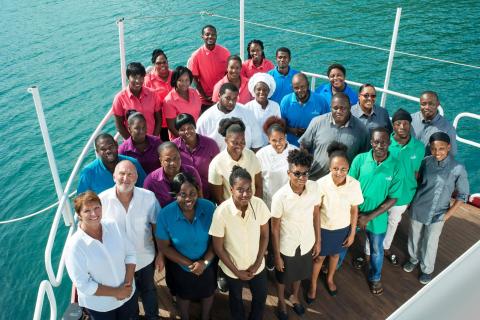 Corporate team in colorful shirts on a boat at a team-building event