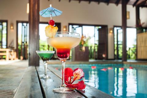 Tropical cocktails by a luxurious pool, ideal for summertime relaxation.