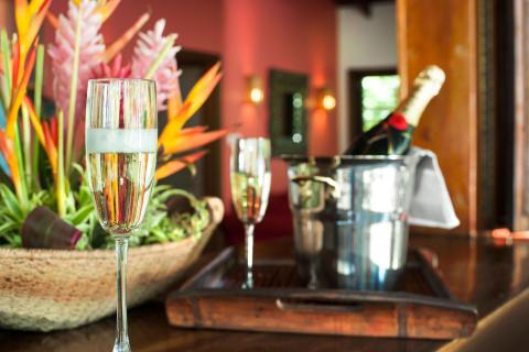 Close-up of champagne glass with bottle in ice bucket, festive decor