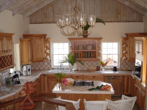 Rustic kitchen with wooden cabinetry, marble island, and modern appliances.