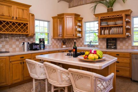 Spacious kitchen with wooden cabinets, island dining, and modern appliances