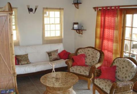 Cozy living room with floral patterned sofa, armchairs, and round coffee table.